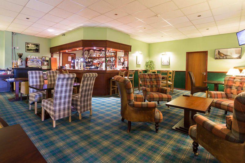 Restaurant bar with beer on tap, tables and bar stools