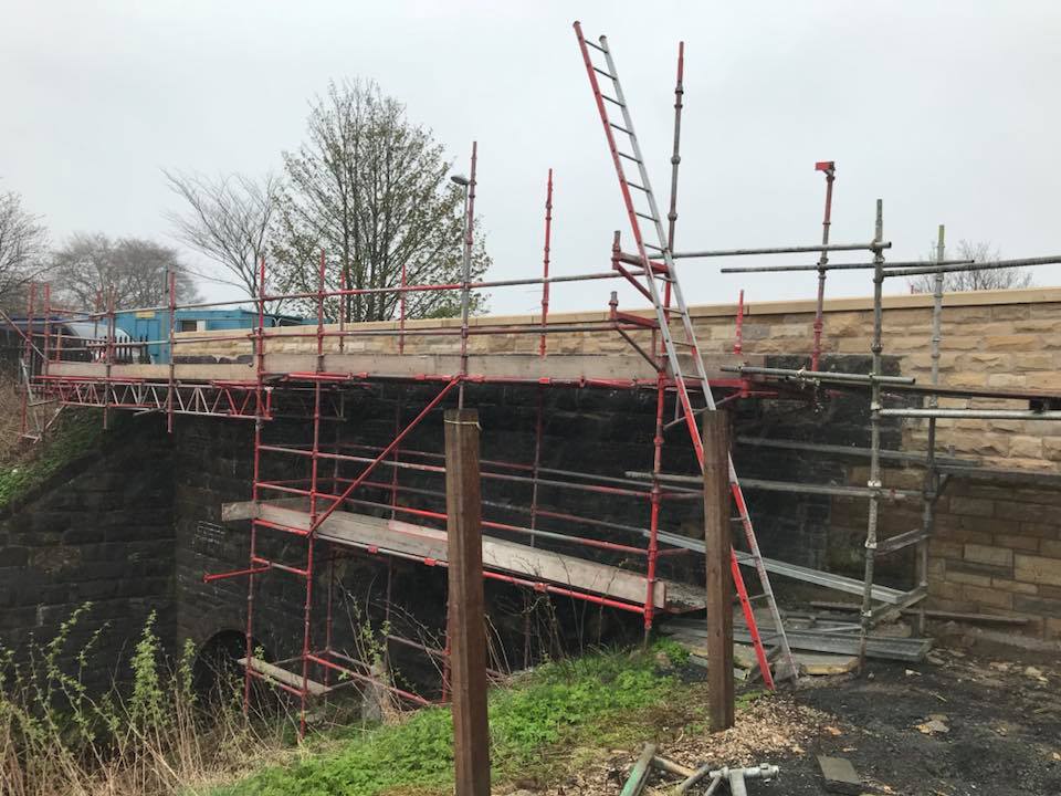 scaffolding over garden wall