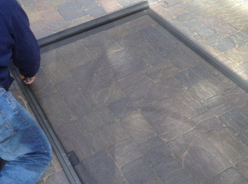 Cleaning Windows — Man replacing ripped old screen in Reno, NV