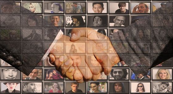 A close up of two people shaking hands with several photos of people in the background.