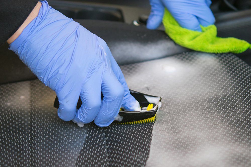 Person Cleaning Car Seat — Oklahoma City, OK — Super Clean Full Service Car Wash And Detail Shop