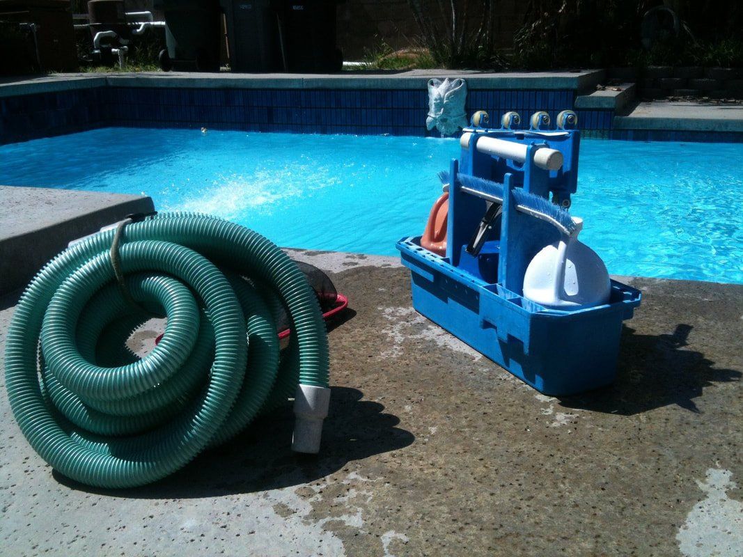pool cleaning supplies next to a swimming pool