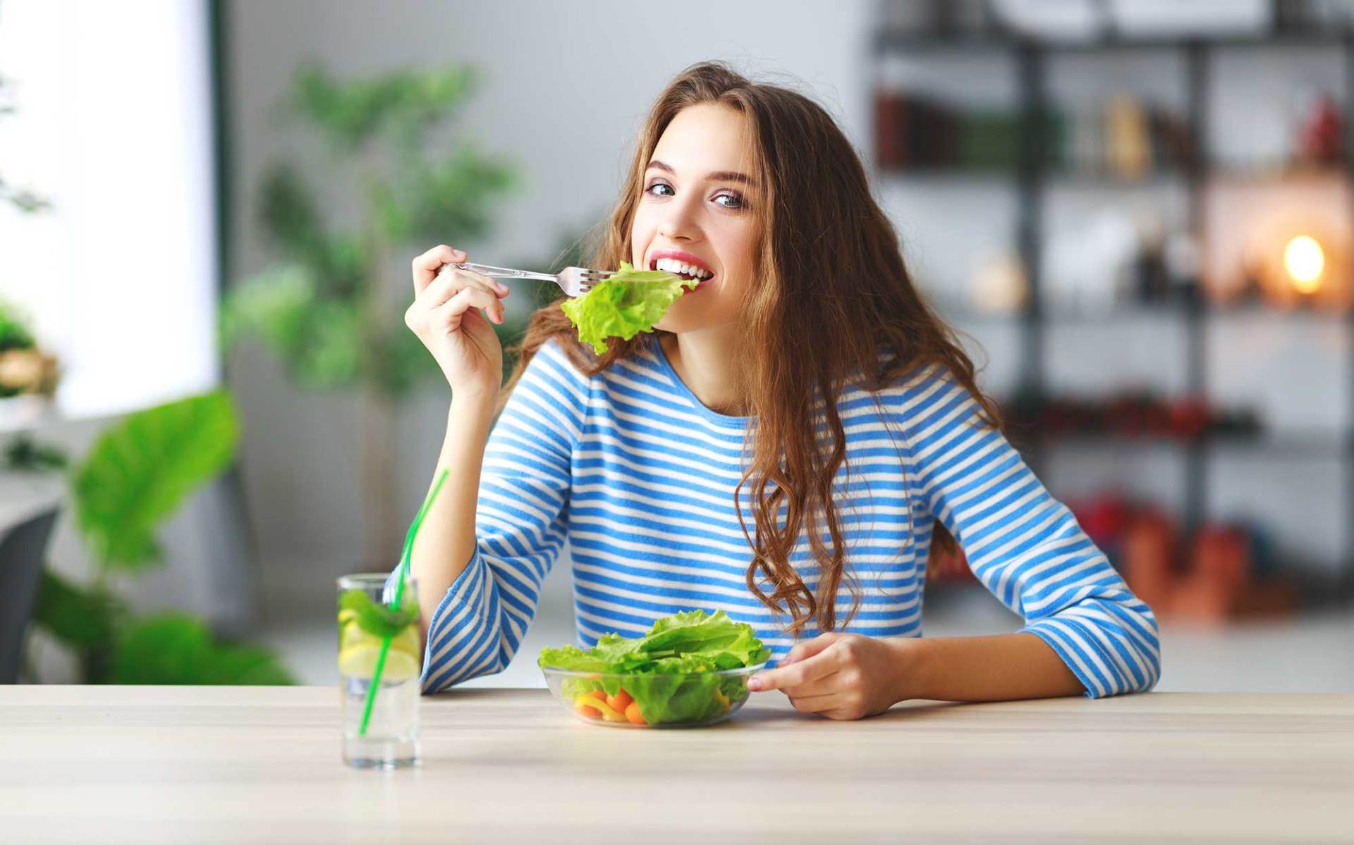 Girl Eating Salad in The Morning in Kitchen — Hampton, VA — Doctors Weight Loss Clinic
