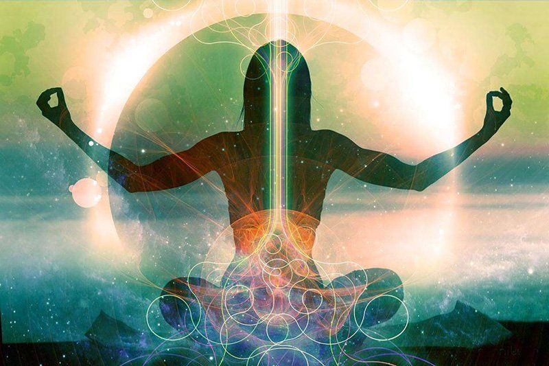 Silhouette of person in lotus pose, arms outstretched, with glowing energy emanating from the body.