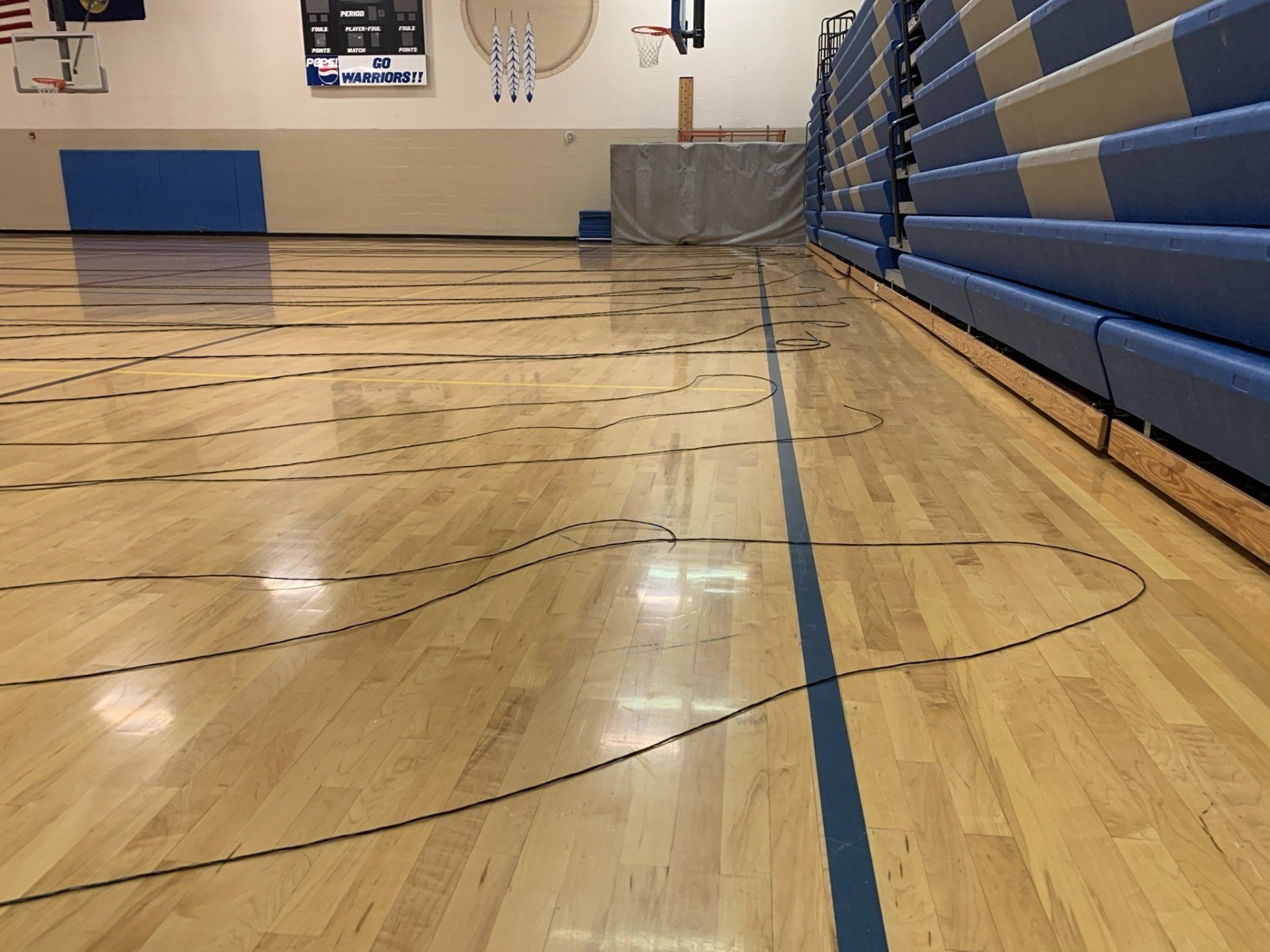 A basketball court with a blue line on the floor