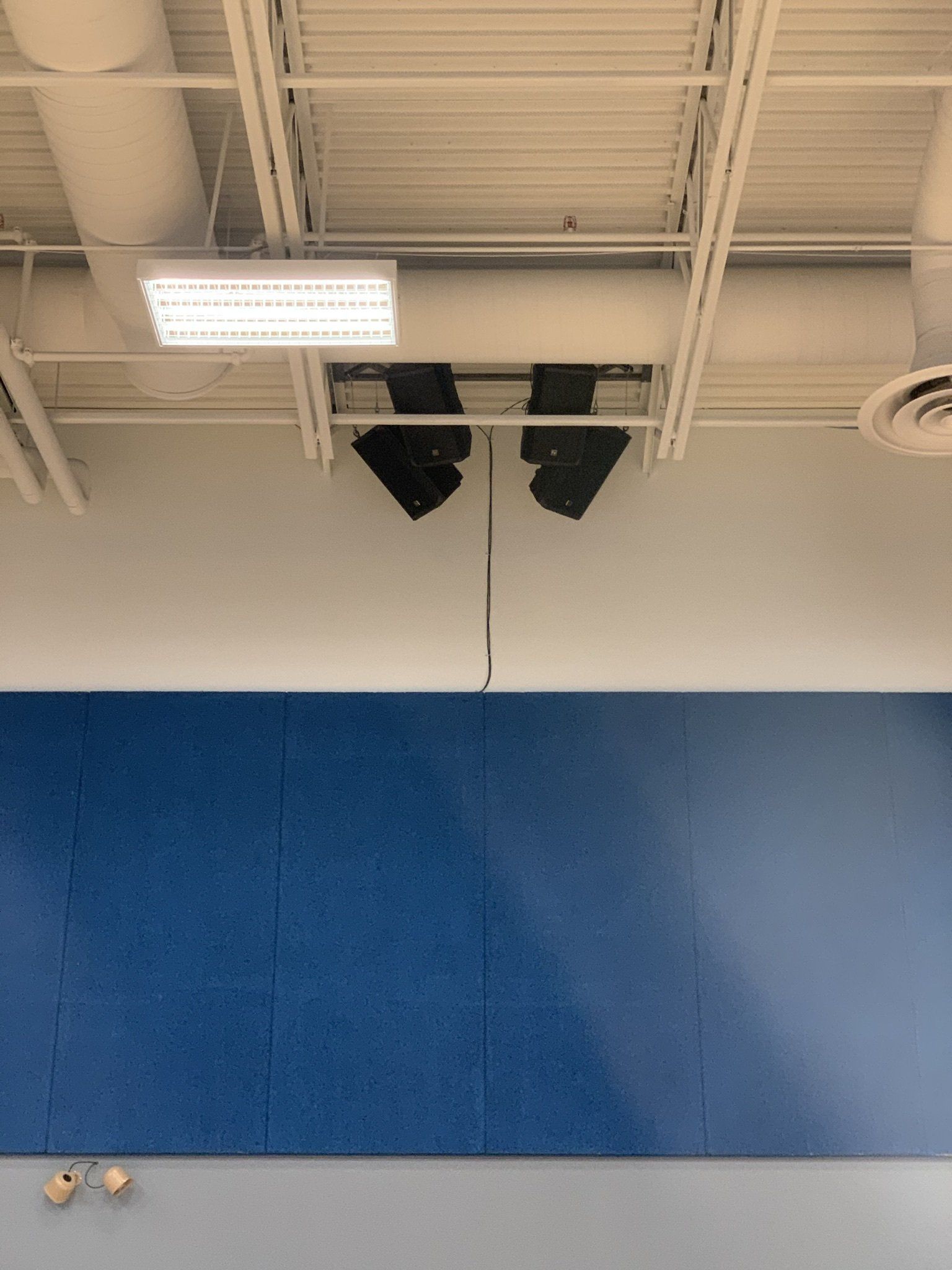 A room with a blue wall and a white ceiling.