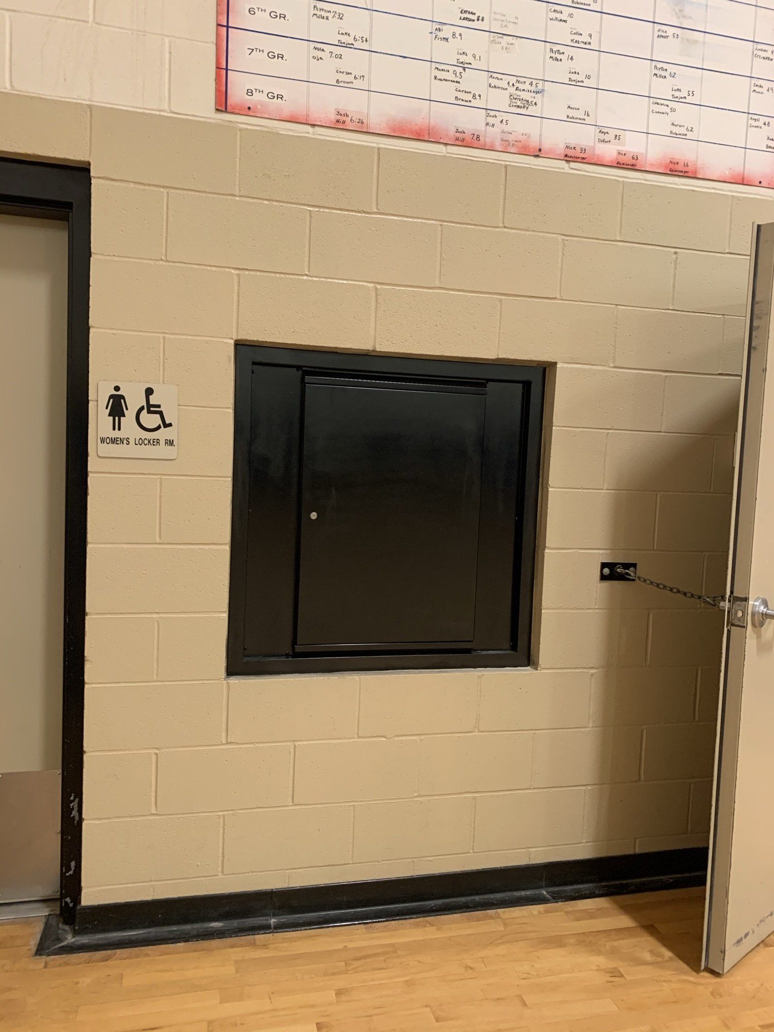 A brick wall with a handicap sign on it