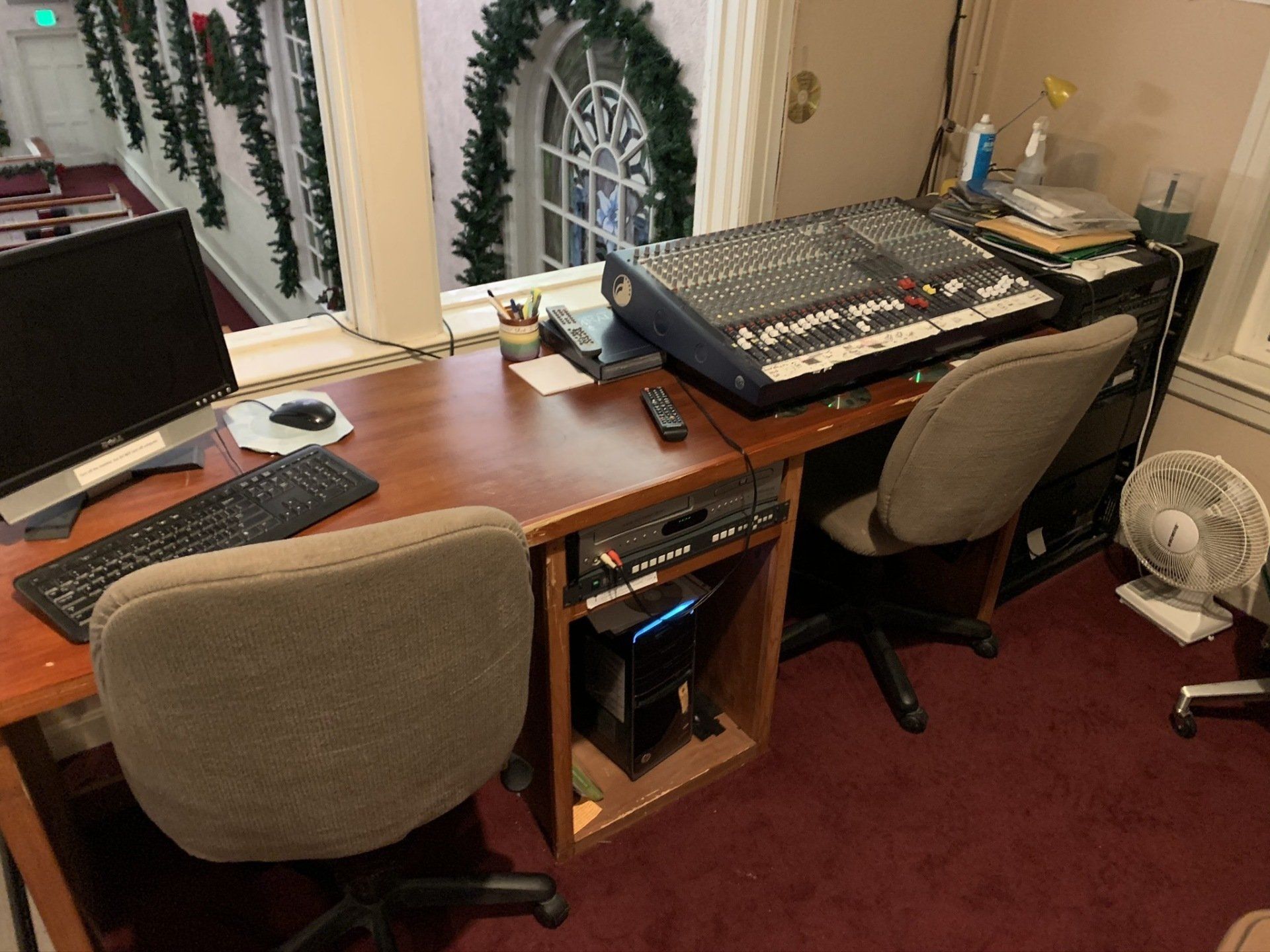 A desk with a keyboard and a computer on it