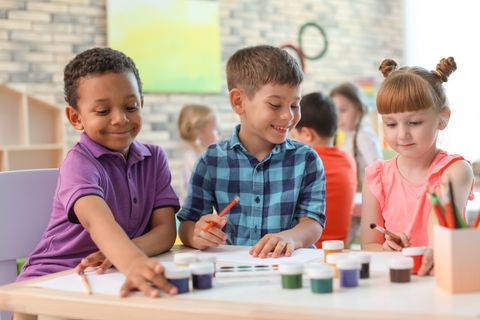 kids preschool kindergarten enjoy and happy jumping on the field of playground after school class is over to retuning home