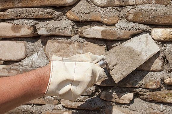 Worker Holding Trowel Tool— Providence, RI — S & A Construction Inc.