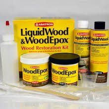 Wood restoration kit: yellow containers of epoxy and liquid wood, with mixing tools.