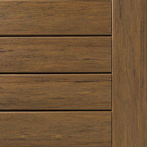 Close-up of brown composite decking planks and a vertical border.