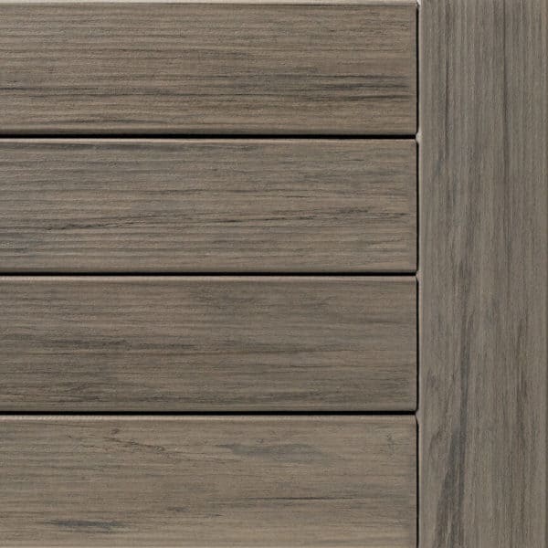 Close-up of composite deck boards in shades of gray. Four horizontal planks next to a vertical board.