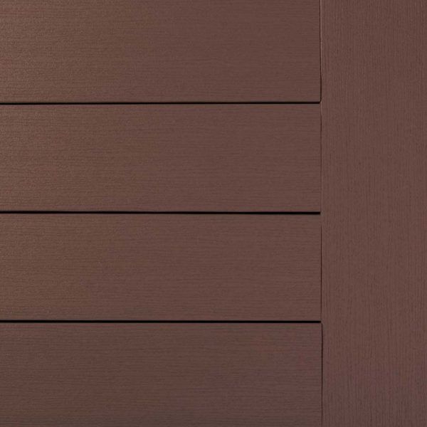Close-up of brown composite decking boards with vertical trim on the right.