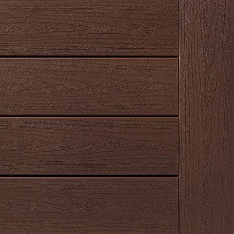 Brown composite decking and trim boards.