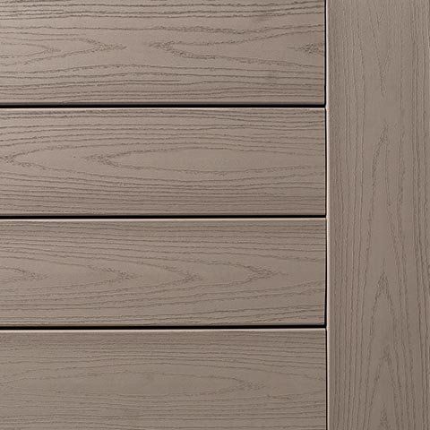 Close-up of composite decking in a light taupe color, showing wood grain texture.