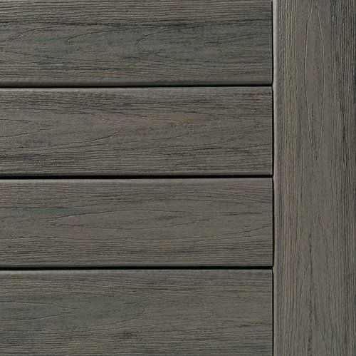 Gray composite decking boards with a textured grain.