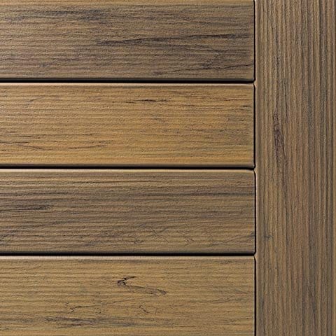 Close-up of composite deck boards with a brown, weathered appearance.
