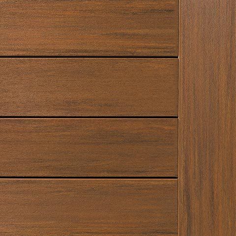 Brown composite decking with vertical edge, wood grain texture.