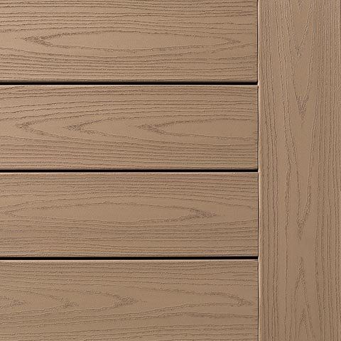 Close-up of composite wood decking boards in shades of brown with a wood grain texture.