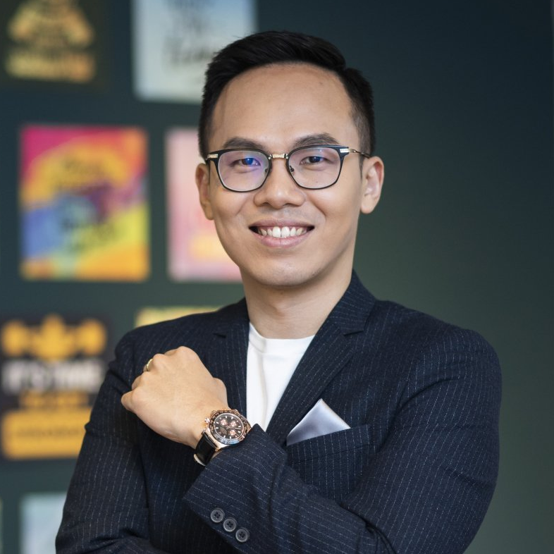 A man in a suit and glasses is wearing a watch on his wrist.
