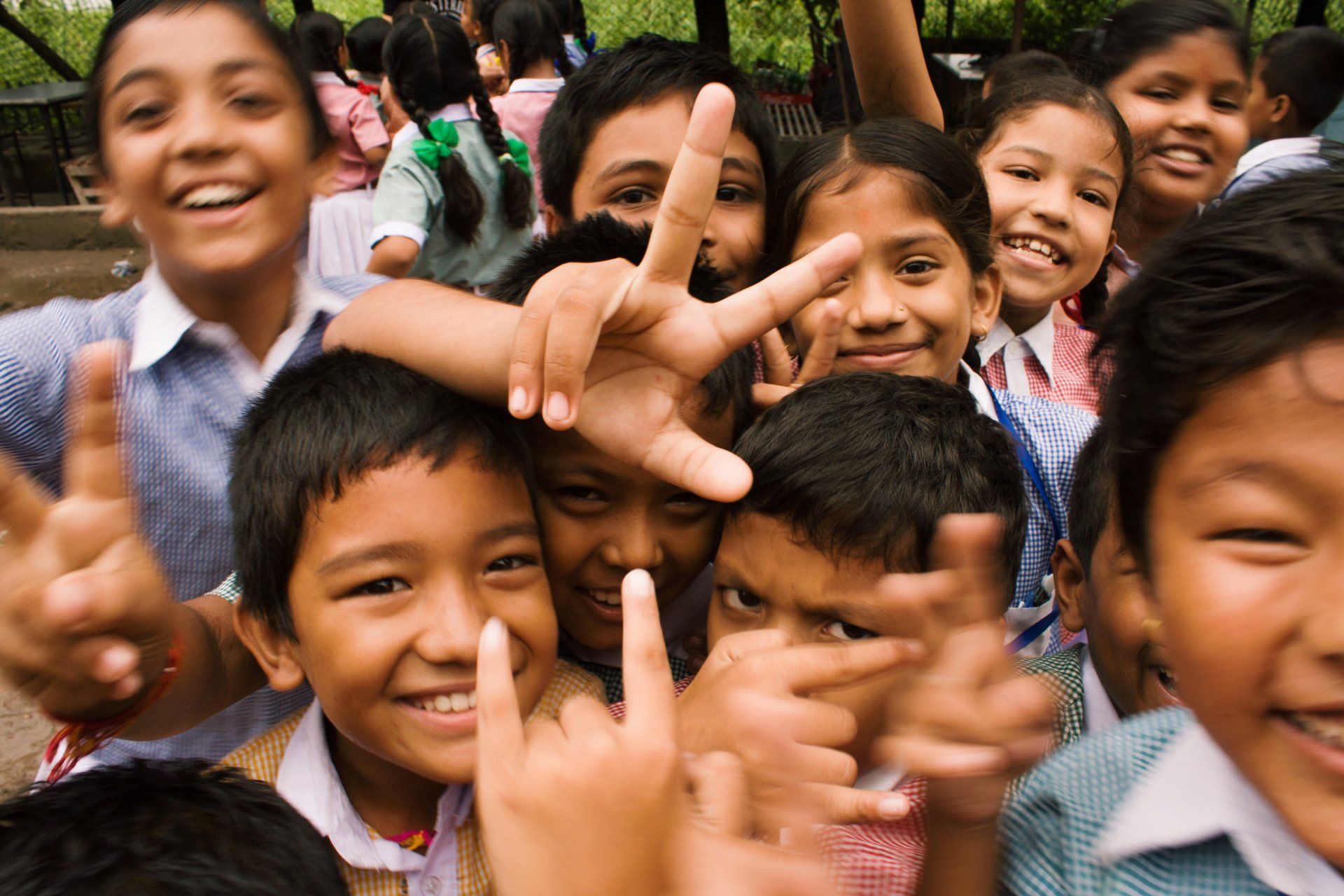 Photo by Rebecca Zaal A group of children are making a peace sign with their hands