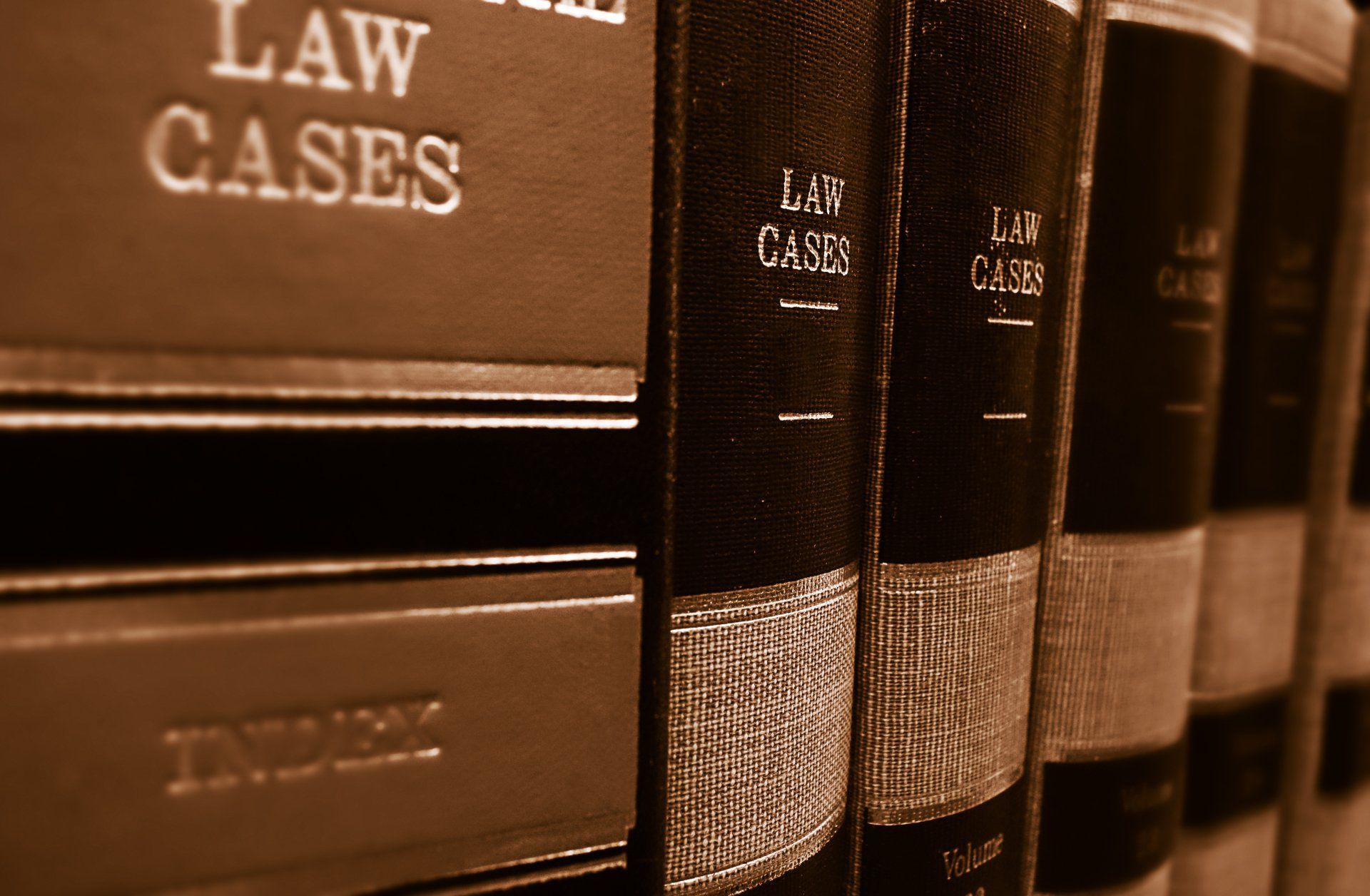 A row of law cases books are lined up on a shelf