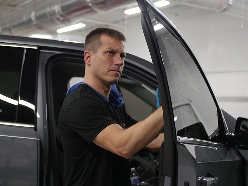 A Man Installing a Car Window Tint — Greenville, SC — iTint
