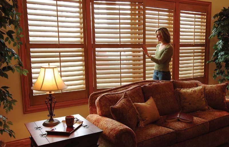 A woman inspecting the completed shutter installation in Brooklyn, NY