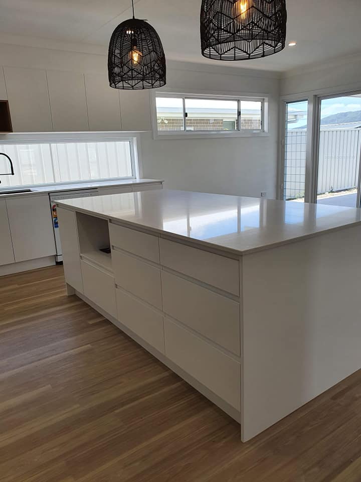 Large White Kitchen Island With Lights Near Door — DMB Kitchens in Port Macquarie, NSW
