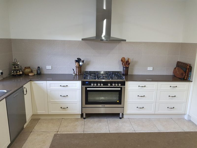 Luxury home interior boasts Beautiful kitchen with custom white shaker cabinets — DMB Kitchens in Port Macquarie, NSW