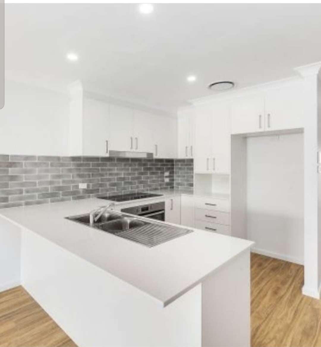 White Kitchen With Bricked Backsplash Design
