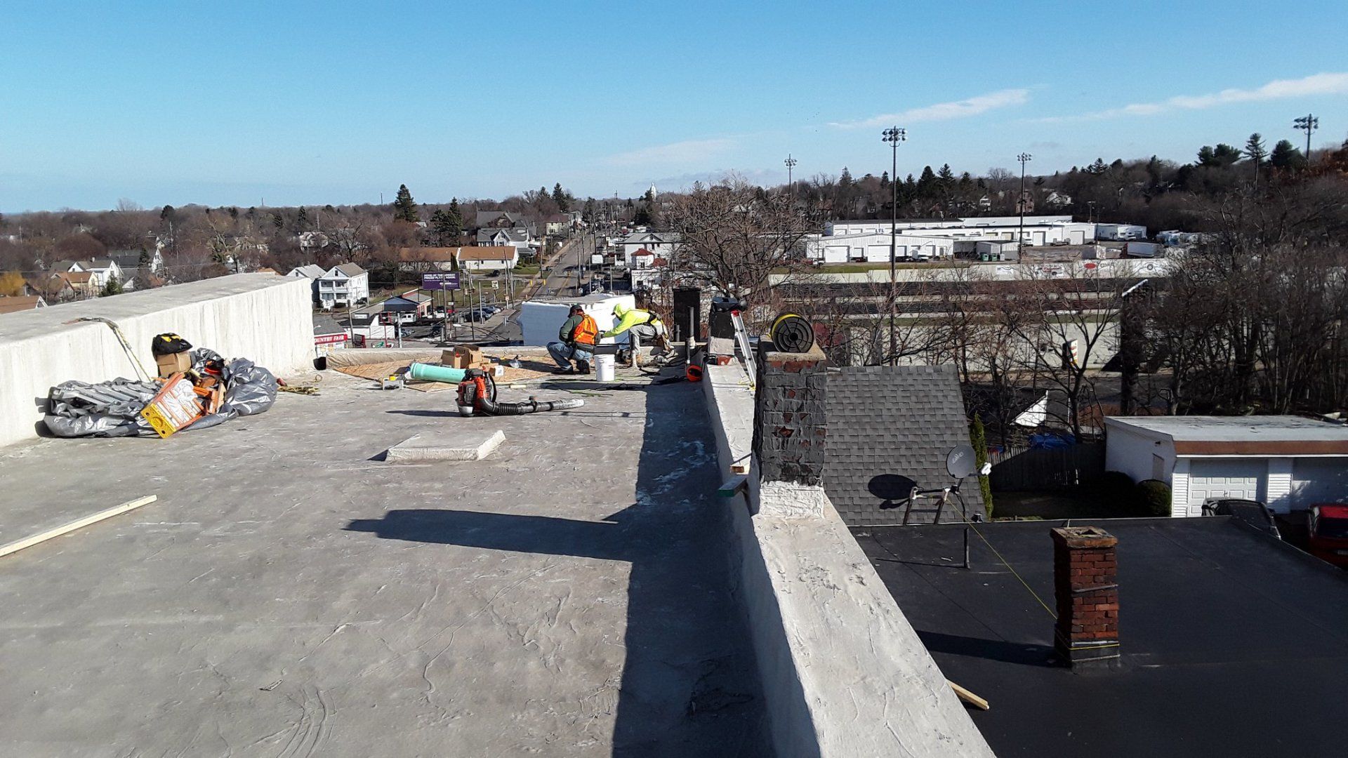 A group of people are working on the roof of a building.