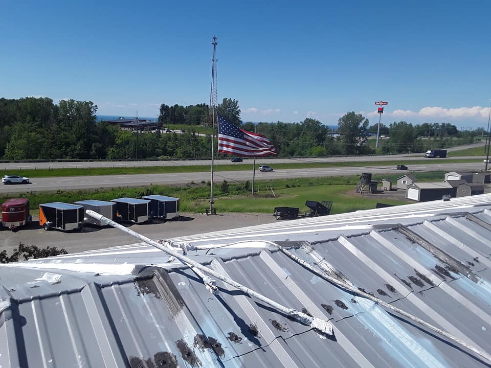 The roof of a building with an american flag in the background