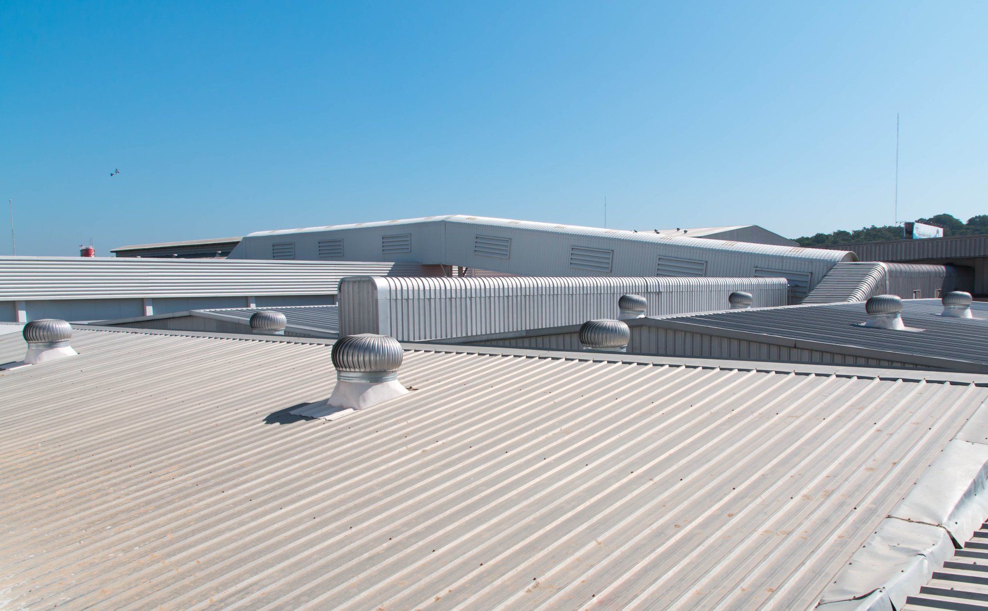 The roof of a building with a blue sky in the background.