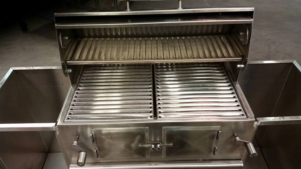A stainless steel grill with the lid open