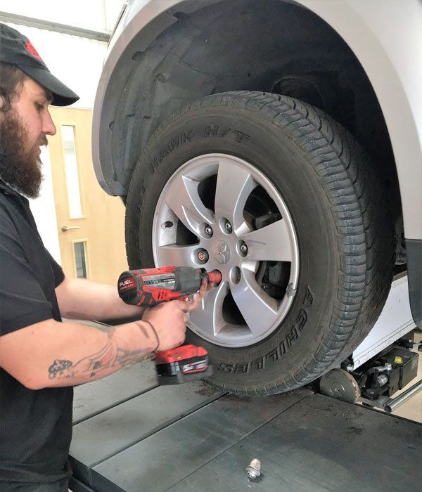 man putting back a wheel