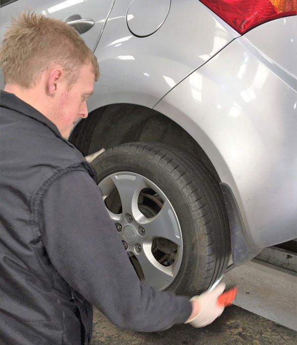 man inspecting wheel