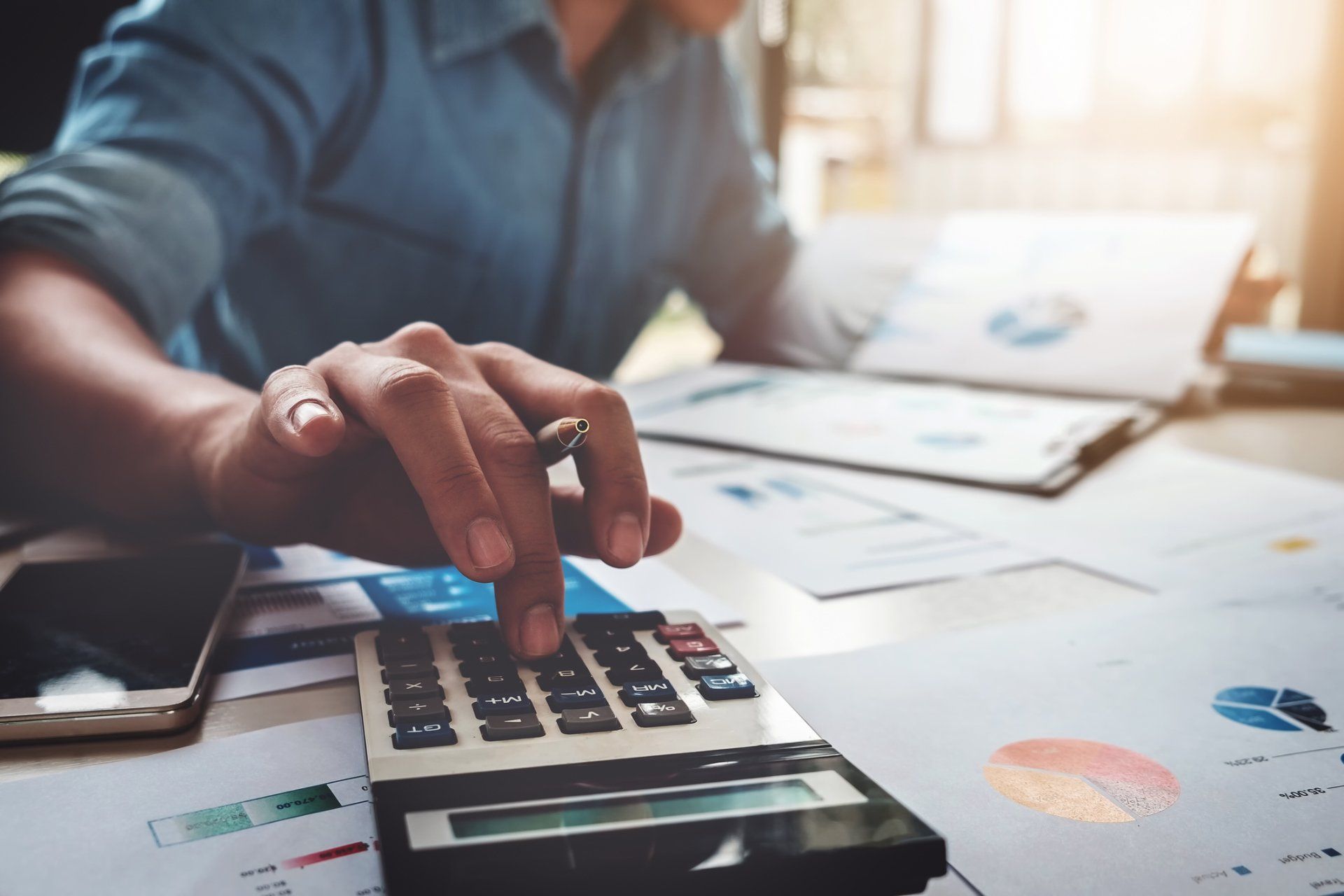 Accounting Audit Review — Man Using a Calculator and Reviewing Papers in Gulfport, MS Accounting Audit Review — Man Using a Calculator and Reviewing Papers in Gulfport, MS