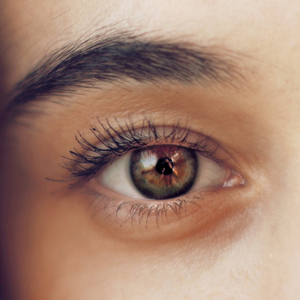 A close up of a woman 's eye with long eyelashes