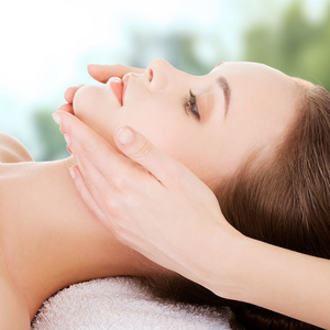 A woman is getting a massage on her face at a spa.