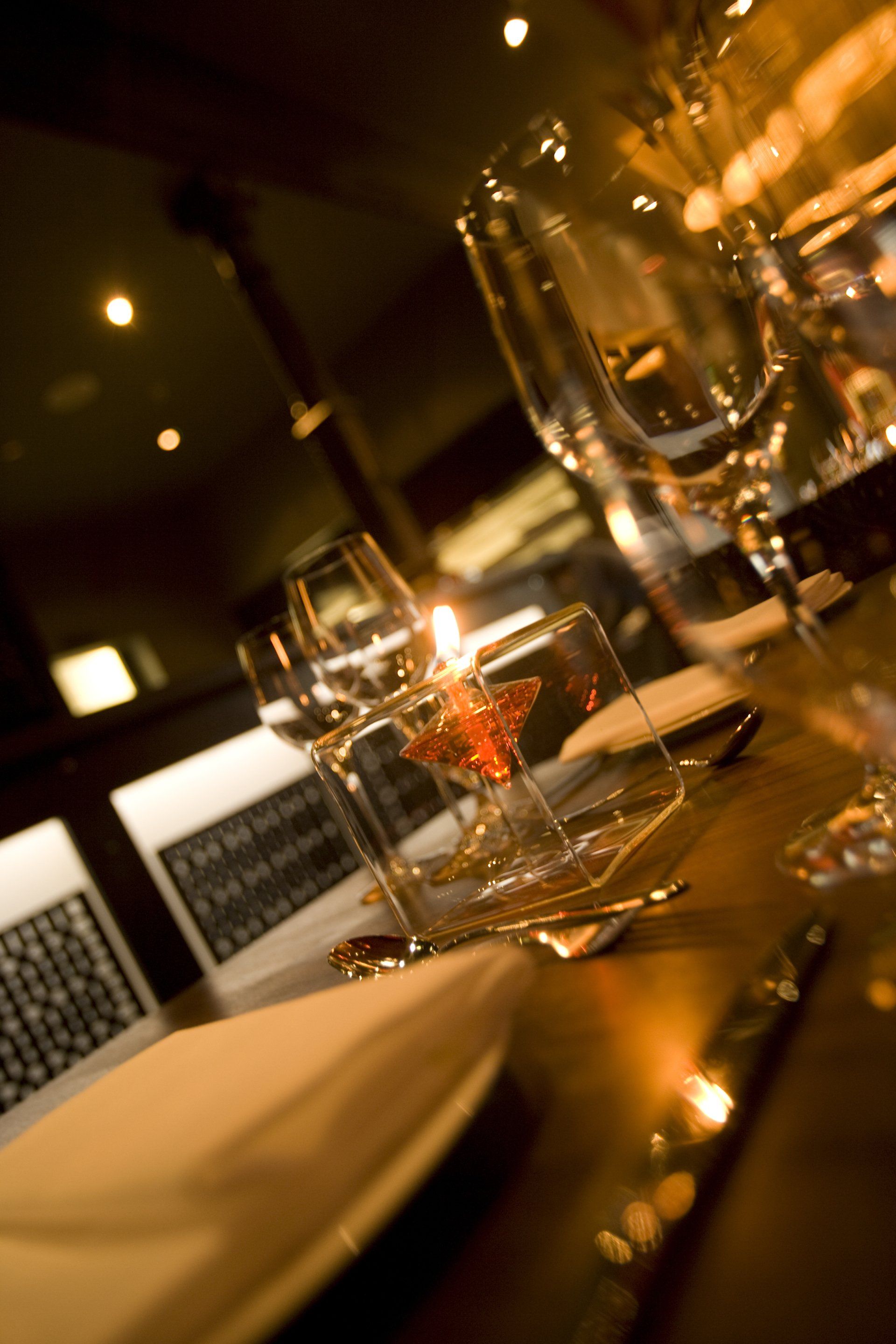 A table with wine glasses and a candle on it