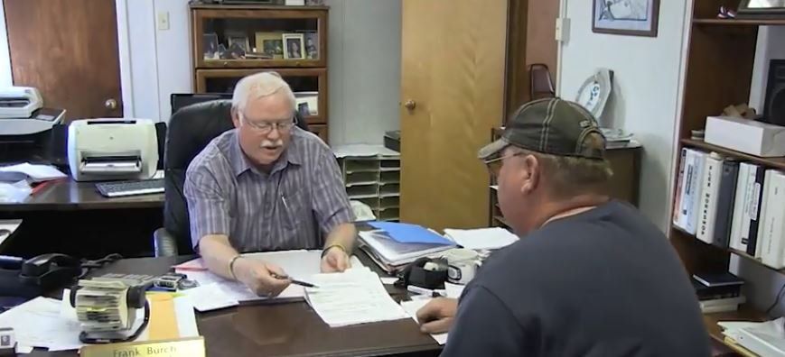 Frank talking with client