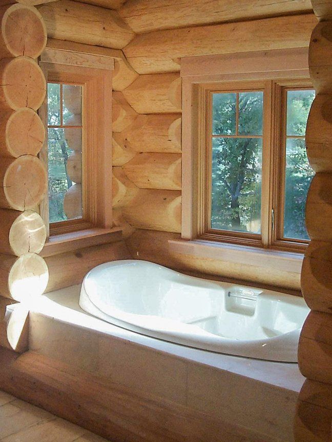 Custom Muskoka Cottage featuring a log cabin bathroom with a tub and two windows