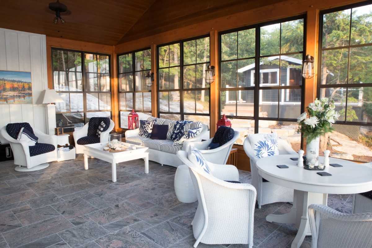 Custom Muskoka Cottage featuring a living room filled with furniture and lots of windows.