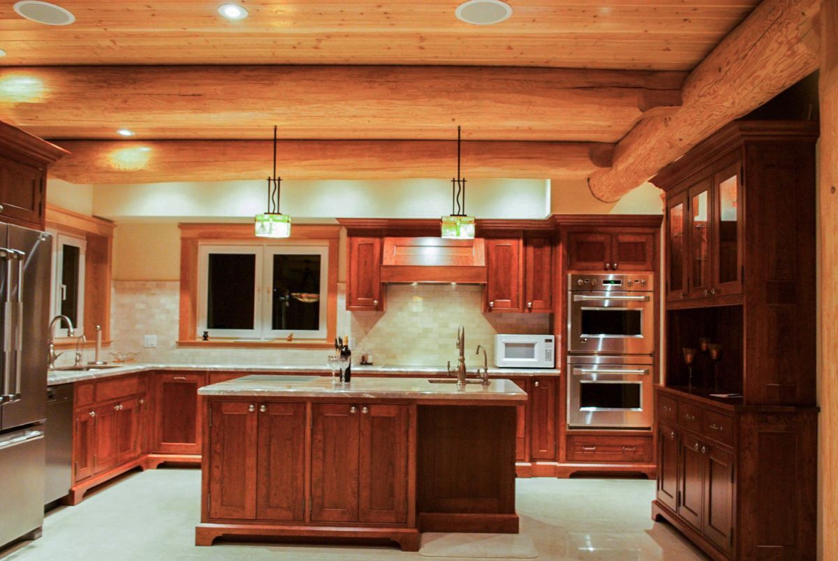 Custom Muskoka Cottage featuring a kitchen with wooden cabinets and stainless steel appliances