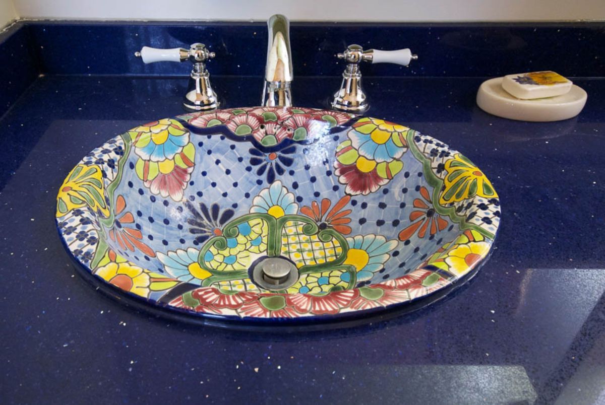 Custom Muskoka Cottage featuring a colorful sink sits on a blue counter top