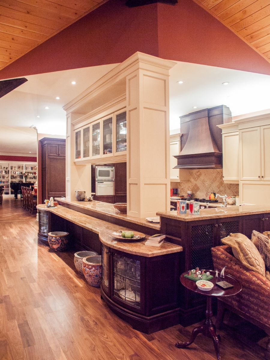 Custom Muskoka Cottage featuring a kitchen with white cabinets and a wooden floor