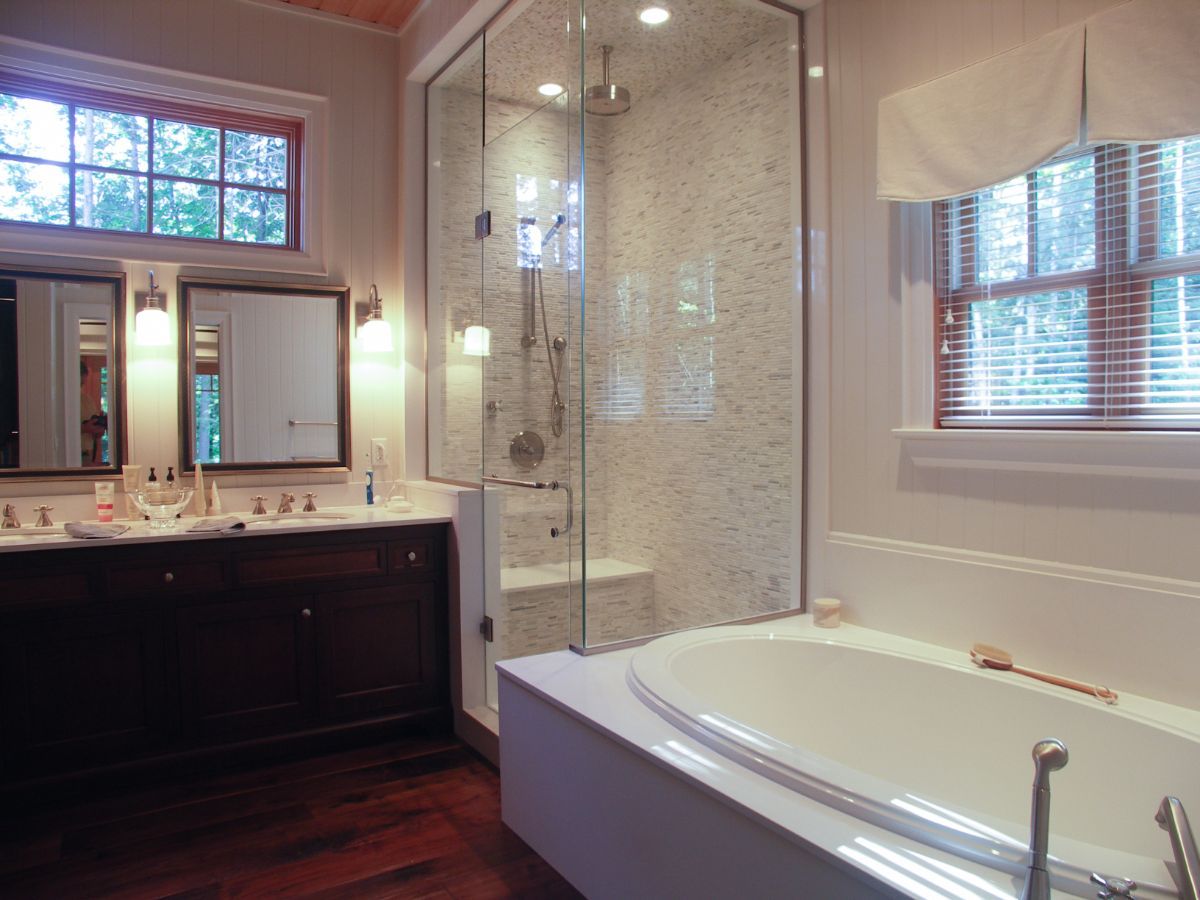 Custom Muskoka Cottage featuring a bathroom with a bathtub and a walk in shower