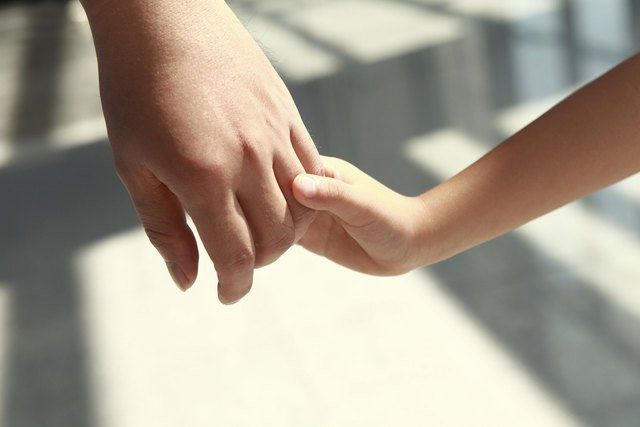 Two people holding hands